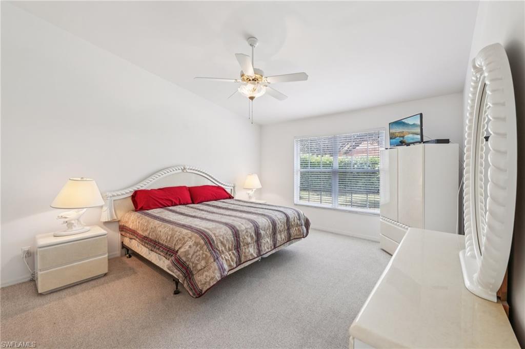 387 Melrose Place Naples, FL 34104 - Photo 11 of 26 a bedroom with a bed and a window