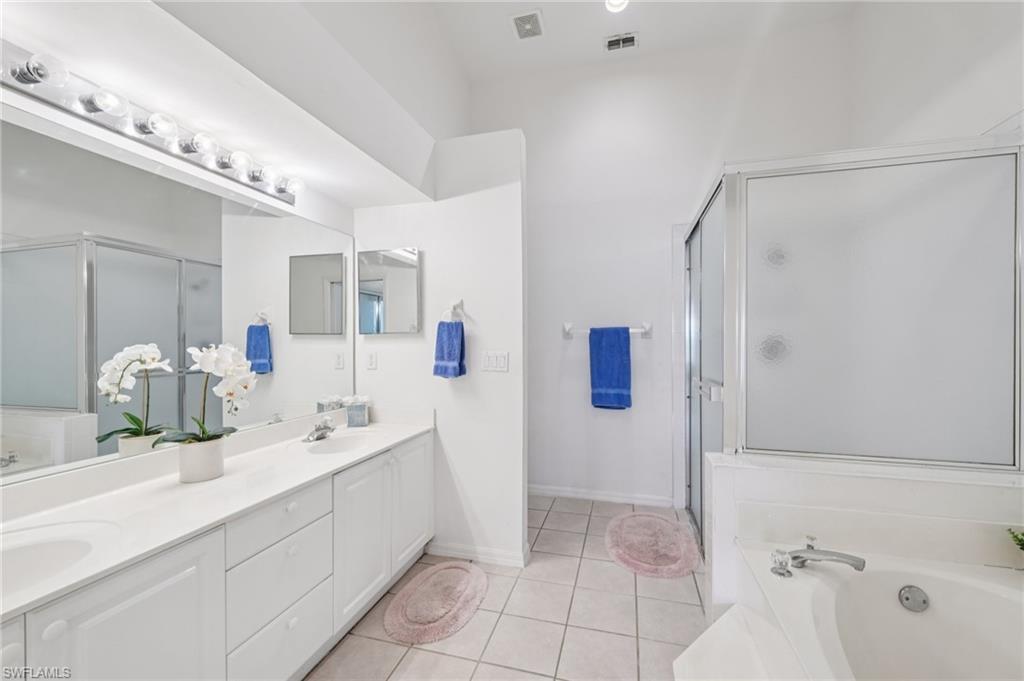 387 Melrose Place Naples, FL 34104 - Photo 12 of 26 a bathroom with a double vanity sink mirror and shower