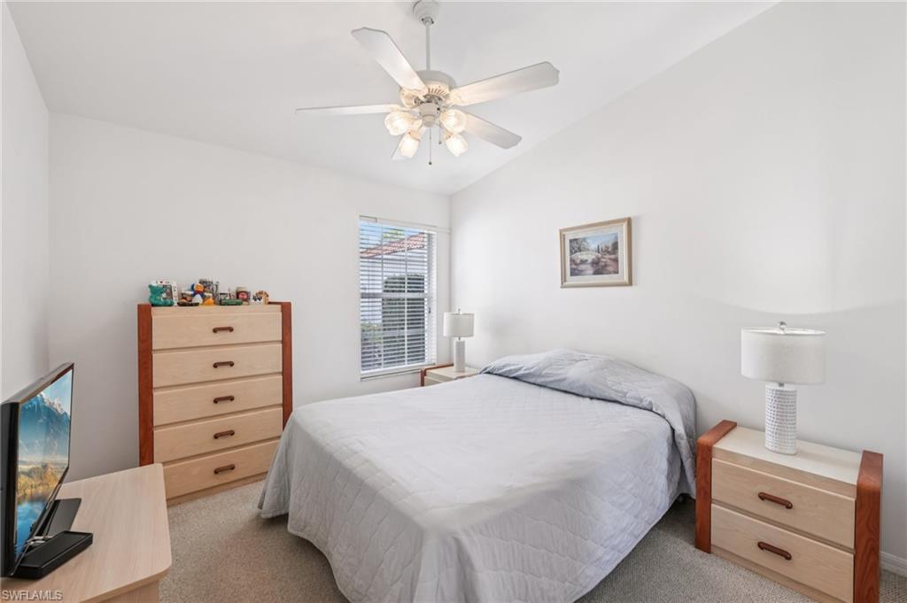 387 Melrose Place Naples, FL 34104 - Photo 15 of 26 a bedroom with a bed and a tv on the dresser