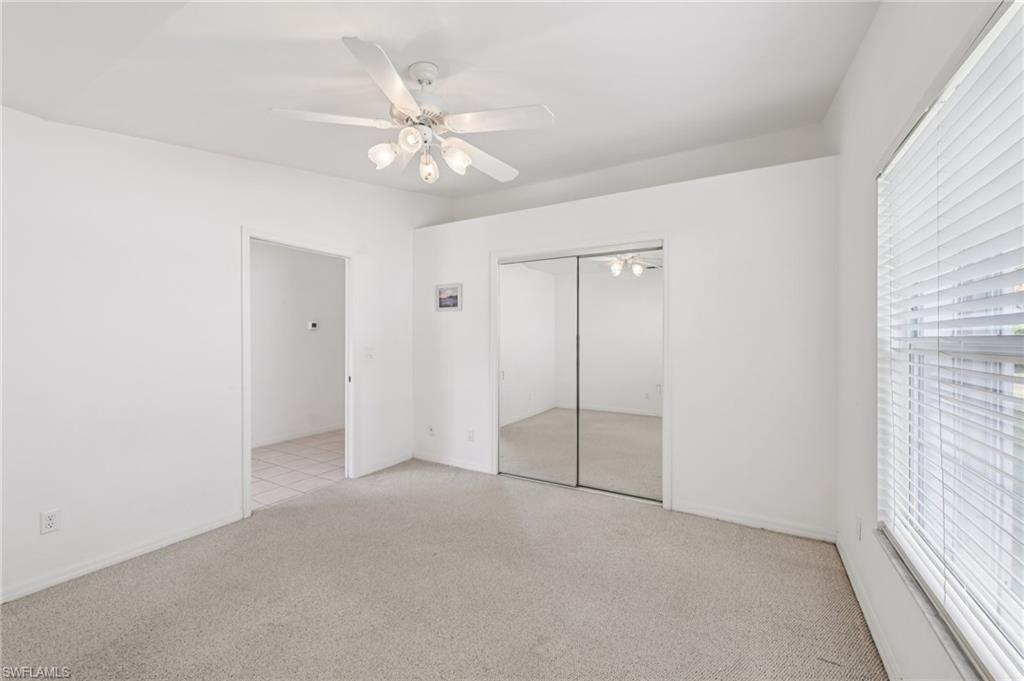 387 Melrose Place Naples, FL 34104 - Photo 16 of 26 an empty room with fan and windows