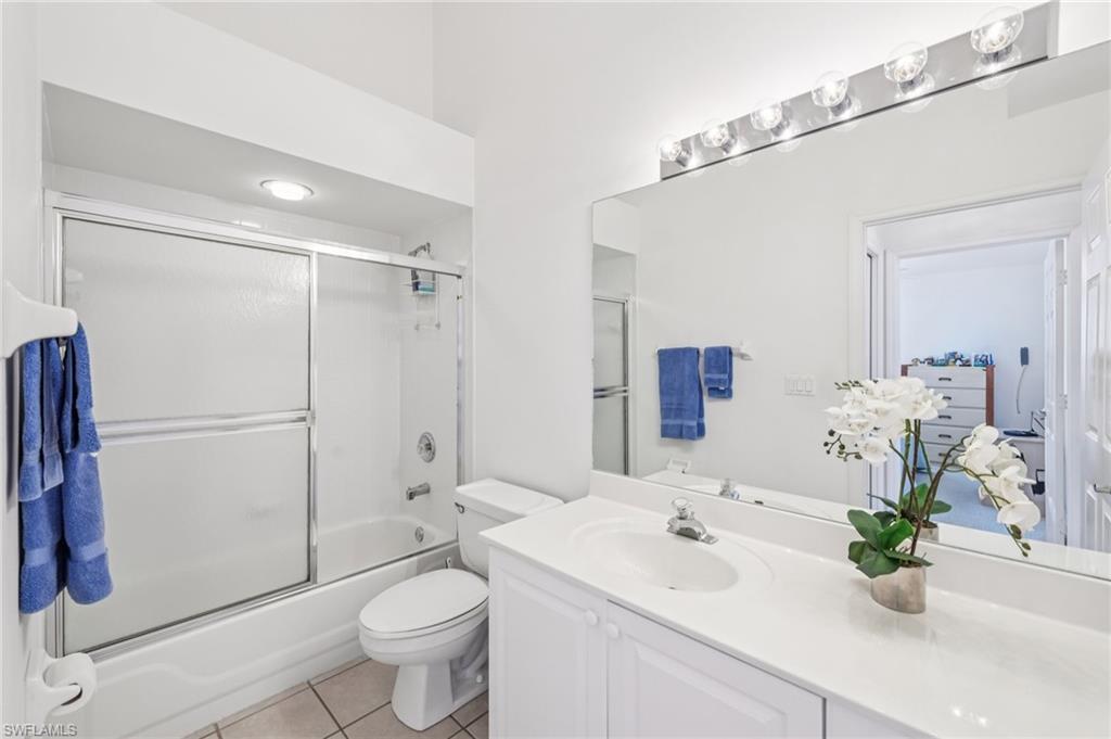 387 Melrose Place Naples, FL 34104 - Photo 17 of 26 a bathroom with a sink a toilet and shower