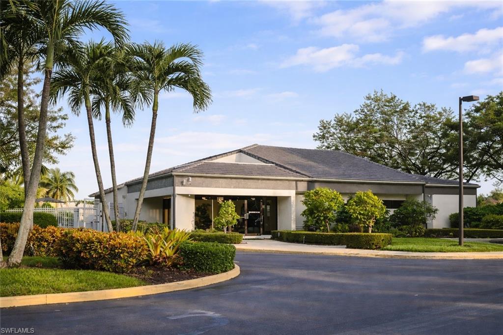 387 Melrose Place Naples, FL 34104 - Photo 23 of 26 a front view of house with yard and green space