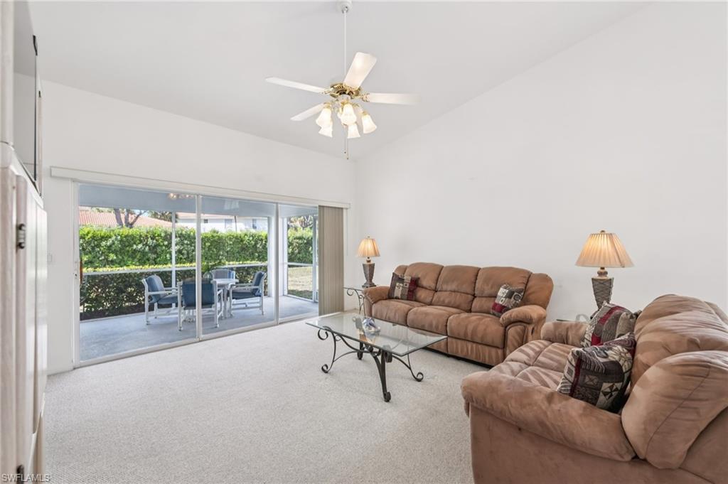 387 Melrose Place Naples, FL 34104 - Photo 10 of 26 a living room with furniture and a large window