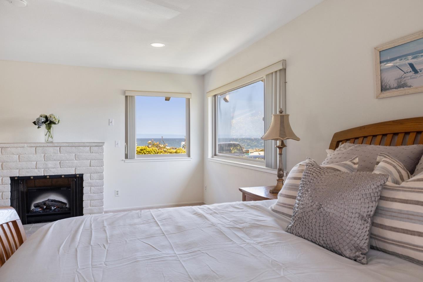 1244 Surf Avenue Pacific Grove, CA 93950 - Photo 12 of 43 a bedroom with a bed and a fireplace