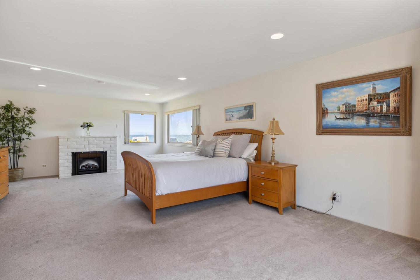 1244 Surf Avenue Pacific Grove, CA 93950 - Photo 14 of 43 a spacious bedroom with a bed and a fireplace