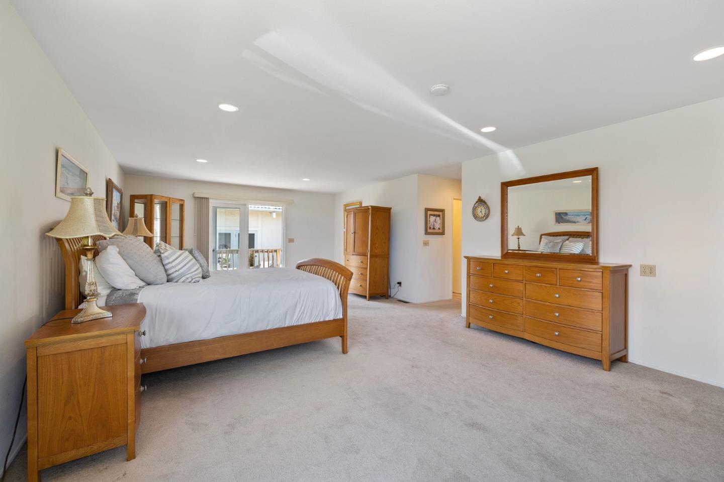 1244 Surf Avenue Pacific Grove, CA 93950 - Photo 16 of 43 a spacious bedroom with a bed and a couch