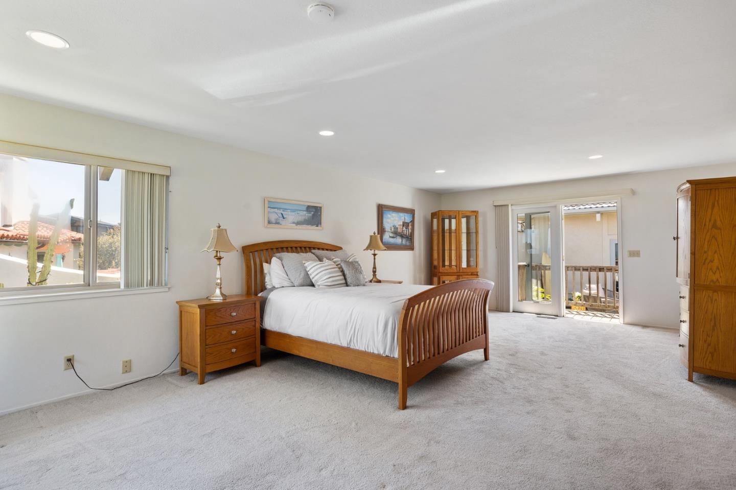 1244 Surf Avenue Pacific Grove, CA 93950 - Photo 18 of 43 a spacious bedroom with a bed and large windows