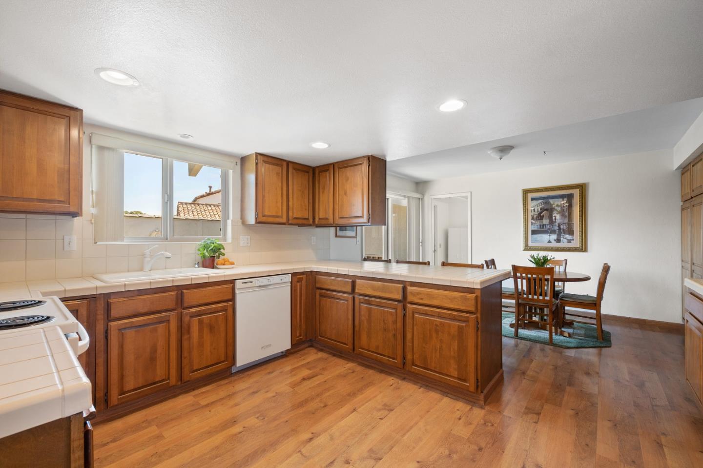 1244 Surf Avenue Pacific Grove, CA 93950 - Photo 22 of 43 a kitchen with a sink cabinets and wooden floor