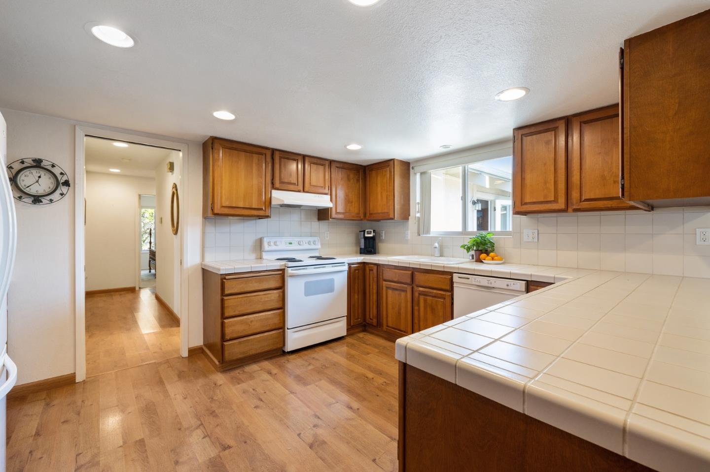 1244 Surf Avenue Pacific Grove, CA 93950 - Photo 26 of 43 a kitchen with granite countertop a sink a stove cabinets and counter space