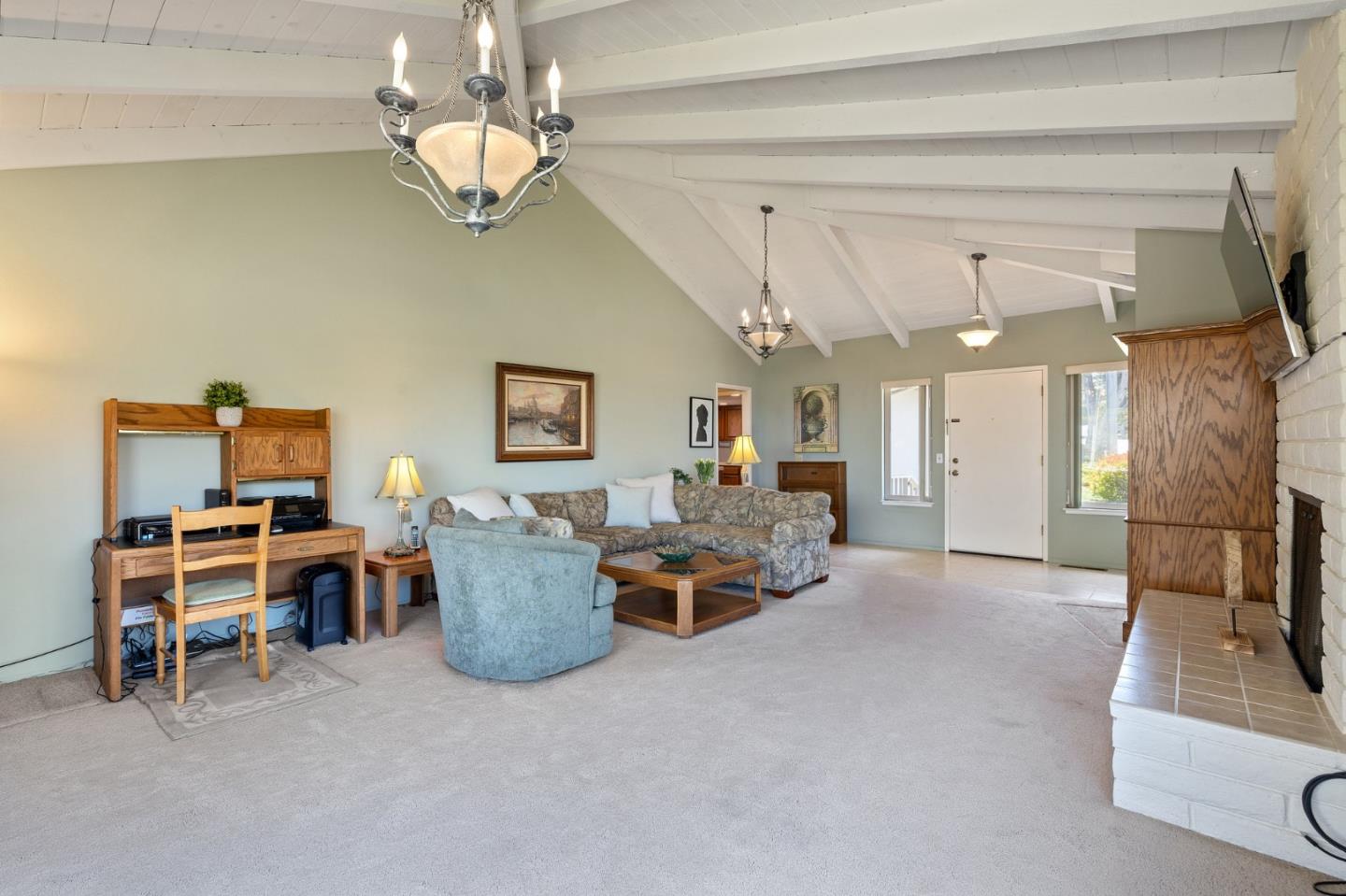 1244 Surf Avenue Pacific Grove, CA 93950 - Photo 9 of 43 a living room with furniture and a chandelier