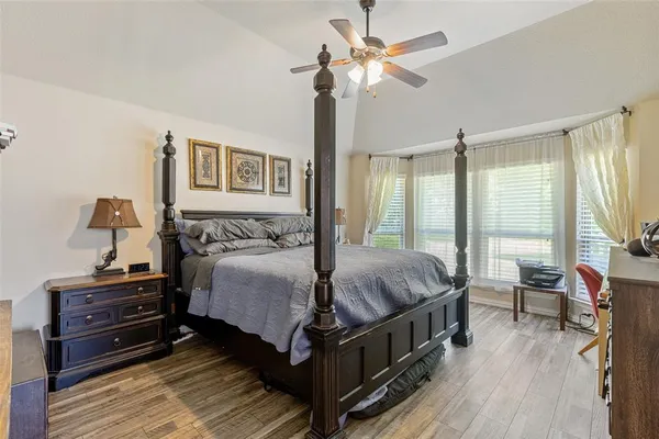 a spacious bedroom with a bed and a chandelier