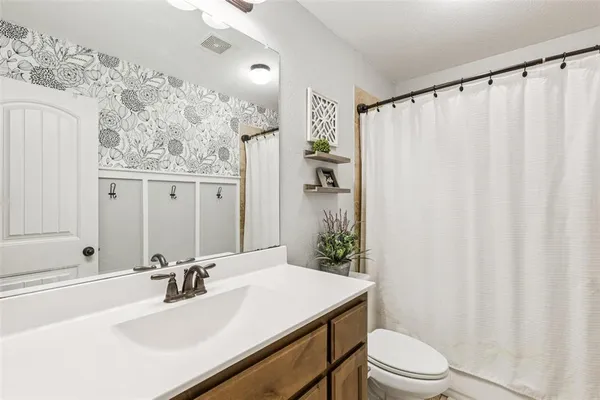 a bathroom with a sink toilet and shower