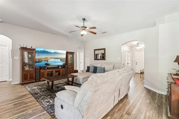 a spacious bedroom with a bed and a flat screen tv