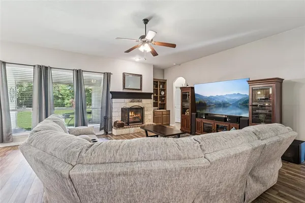 a living room with fireplace furniture and a flat screen tv