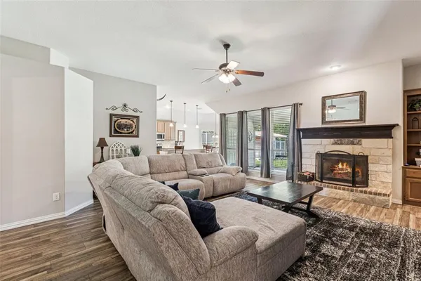 a living room with furniture a large window and a fireplace
