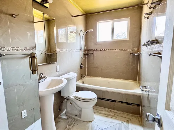 a bathroom with a sink a toilet and a bathtub