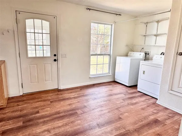 an empty room with windows and cabinet