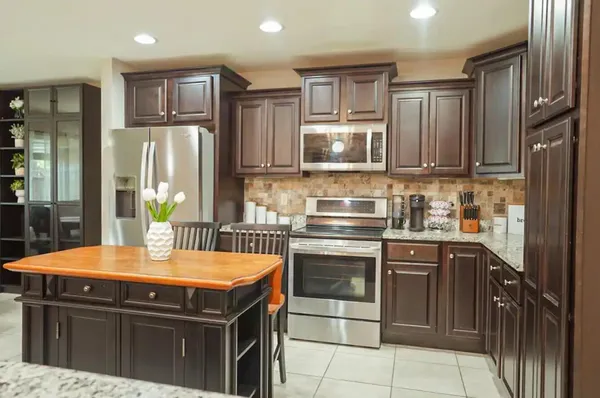 a large kitchen with a table and chairs in it