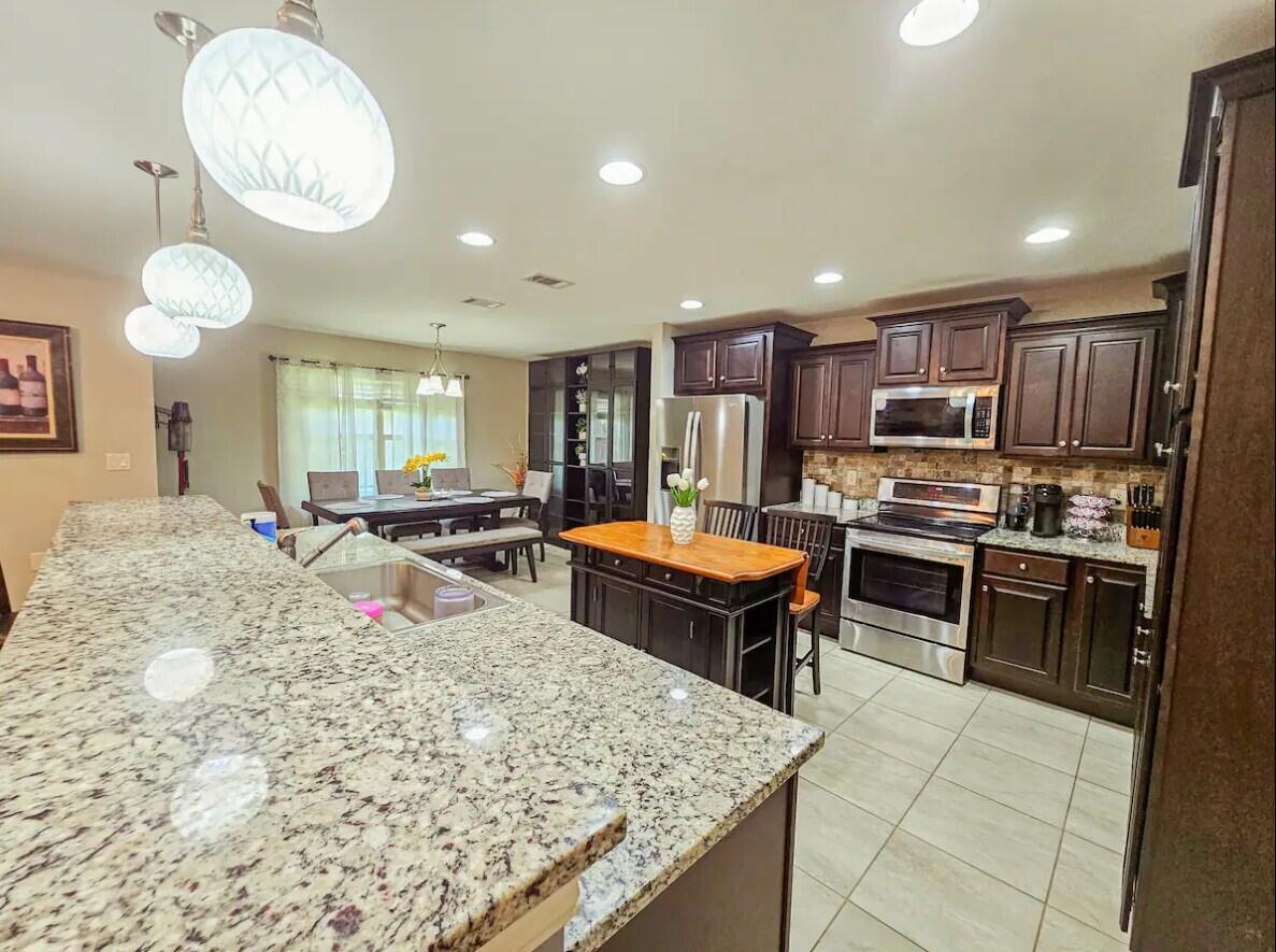 109 Thornhill Road Fort Walton Beach, FL 32547 - Photo 12 of 38 a large kitchen with a table and chairs in it