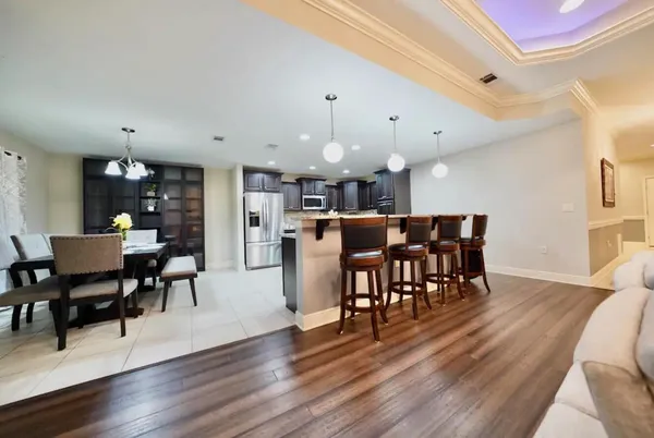 a view of a dining room with furniture and a chandelier