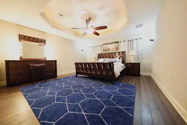 a bedroom with a bed and a dresser