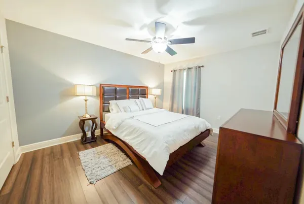 a bedroom with a bed and a window
