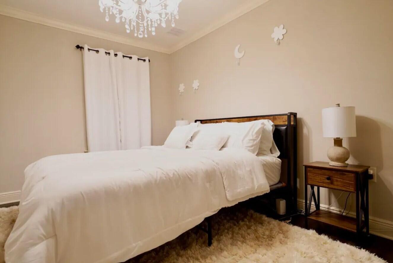 109 Thornhill Road Fort Walton Beach, FL 32547 - Photo 32 of 38 a bedroom with a bed and a chandelier