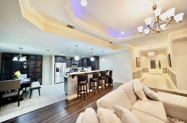 a living room with furniture a dining table and a large window