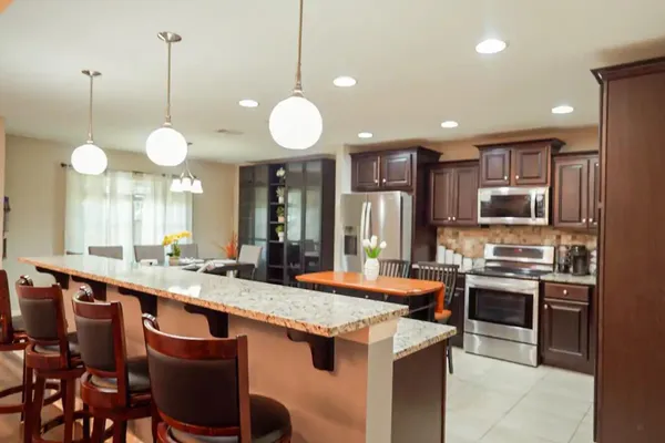 a kitchen with a stove sink and cabinets