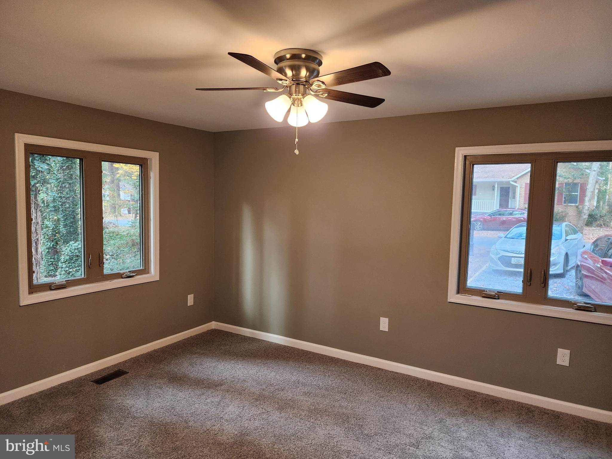 11577 Tomahawk Trail Lusby, MD 20657 - Photo 13 of 28 an empty room with windows and fan