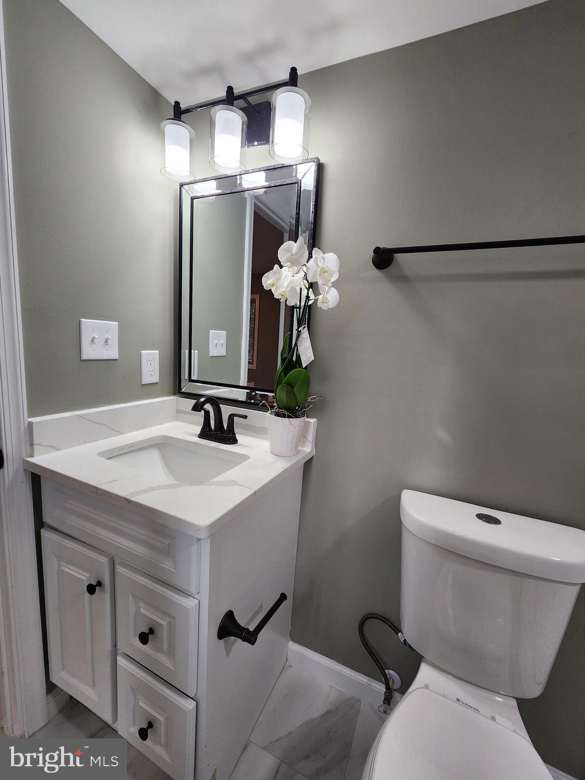 11577 Tomahawk Trail Lusby, MD 20657 - Photo 22 of 28 a bathroom with a toilet sink and mirror