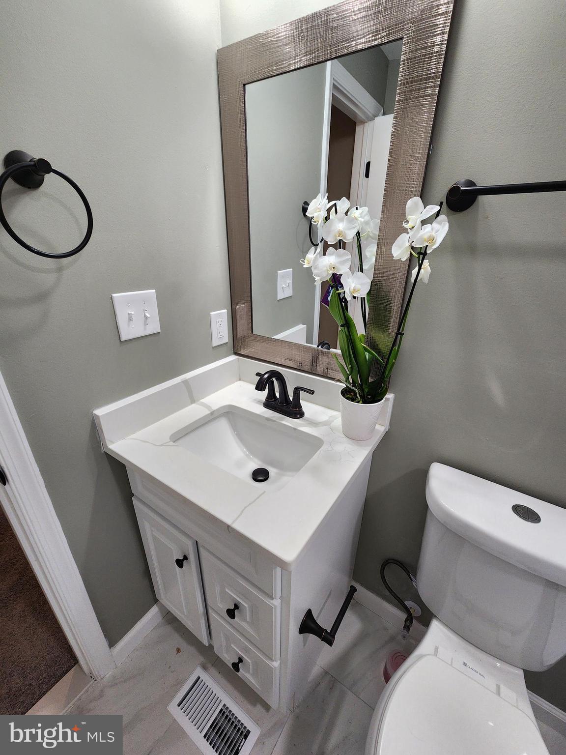 11577 Tomahawk Trail Lusby, MD 20657 - Photo 24 of 28 a bathroom with a toilet sink and mirror