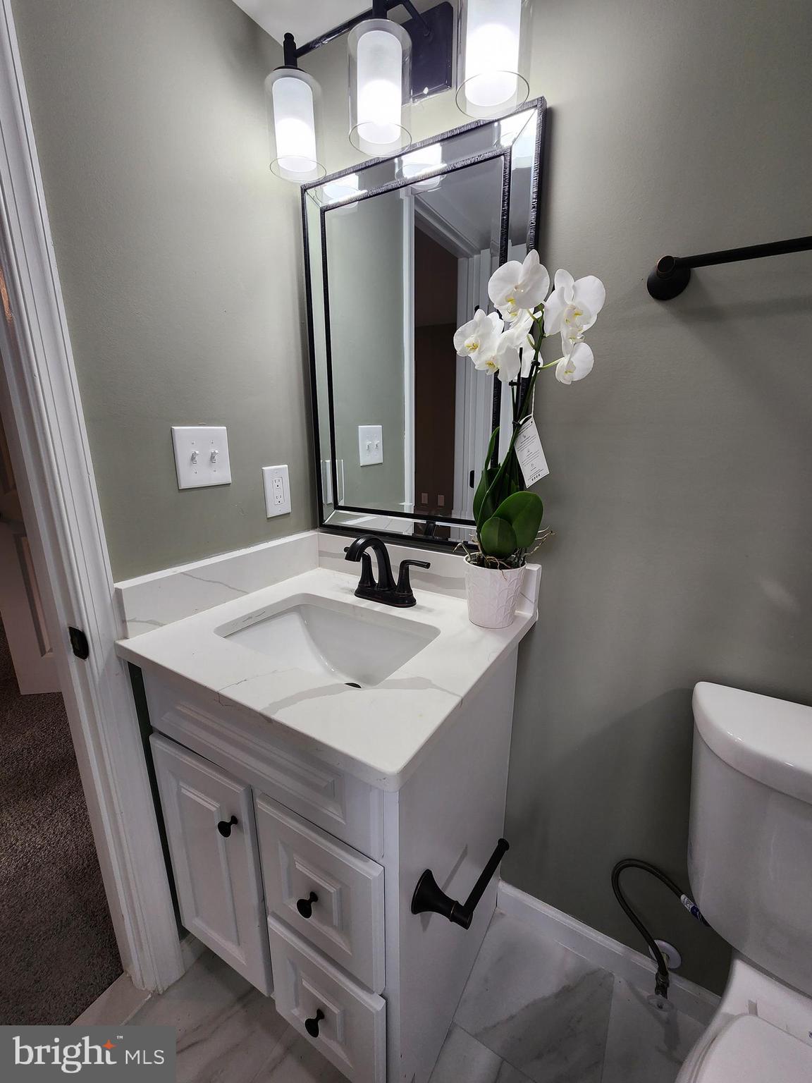 11577 Tomahawk Trail Lusby, MD 20657 - Photo 27 of 28 a bathroom with a sink vanity and a mirror