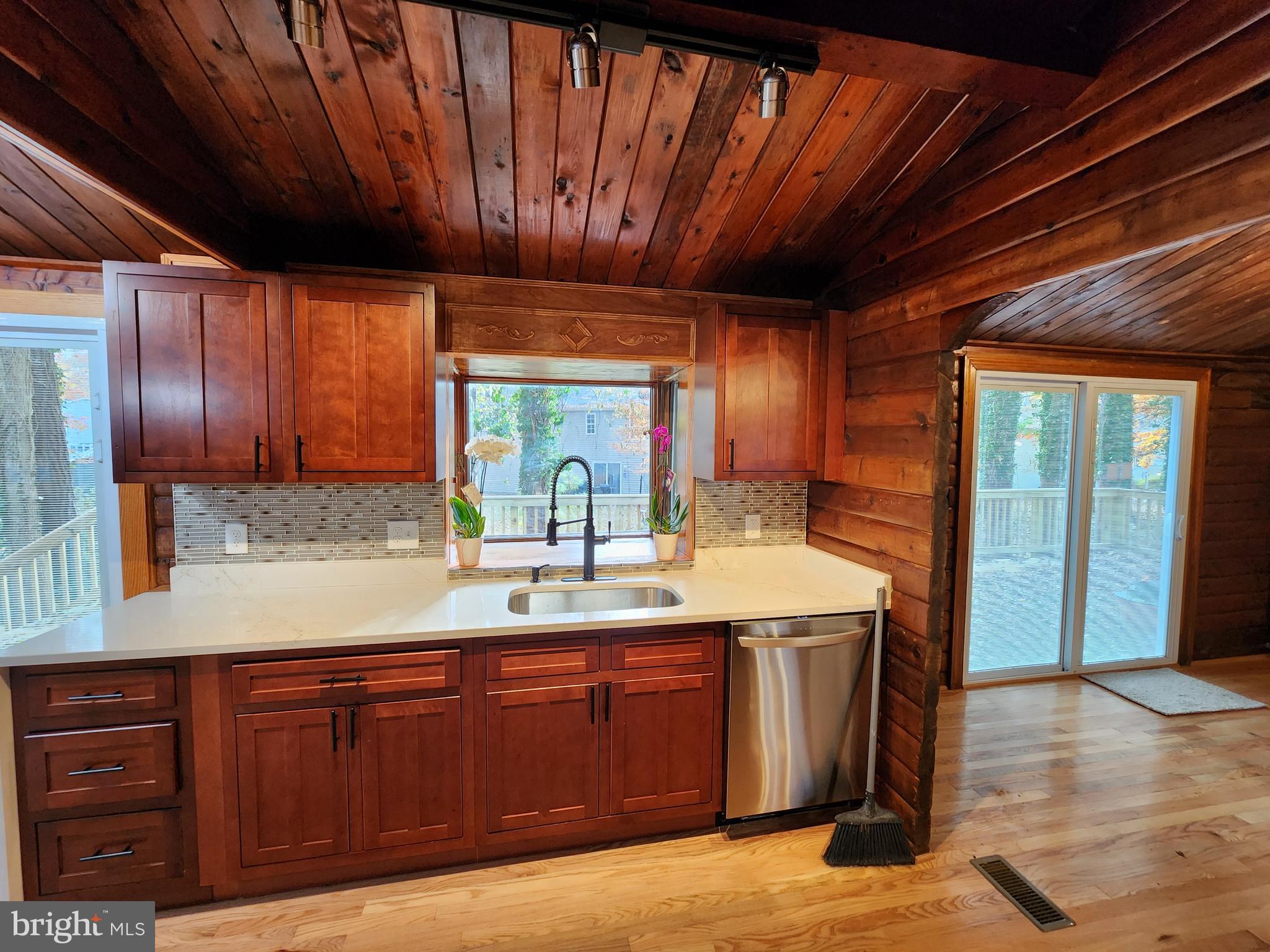 11577 Tomahawk Trail Lusby, MD 20657 - Photo 5 of 28 a kitchen with a sink and wooden cabinets