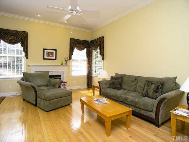 7413 Fontana Ridge Lane Raleigh, NC 27613 - Photo 7 of 25 Gas log fireplace in living room/family room includes a marble surround.