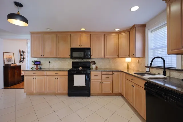 a kitchen with stainless steel appliances granite countertop a sink and cabinets