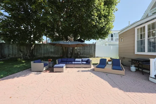 a view of backyard with outdoor seating and green space