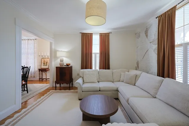a living room with furniture a window and a chandelier