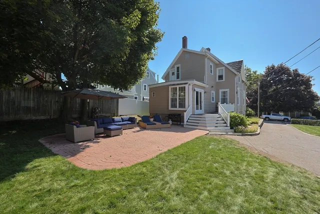 a view of a house with a yard porch and sitting area
