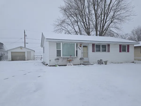 a view of a house with a snow in the yard