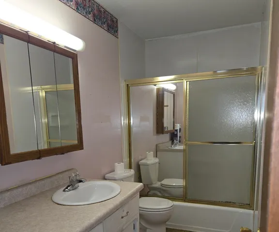 a bathroom with a sink toilet and shower