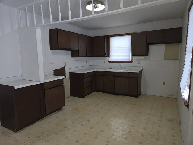 a kitchen with stainless steel appliances granite countertop a sink and a microwave
