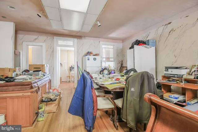 a view of a dining room with furniture a rug and wooden floor