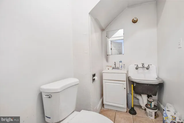 a bathroom with a sink toilet and a mirror