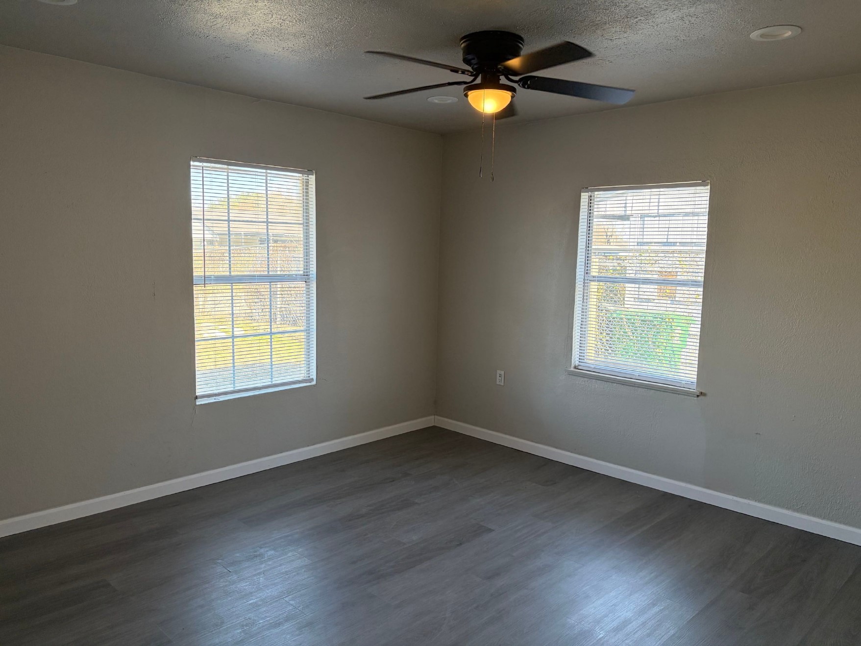 5406 Lyndhurst Drive Houston, TX 77033 - Photo 13 of 17 an empty room with a window and wooden floor