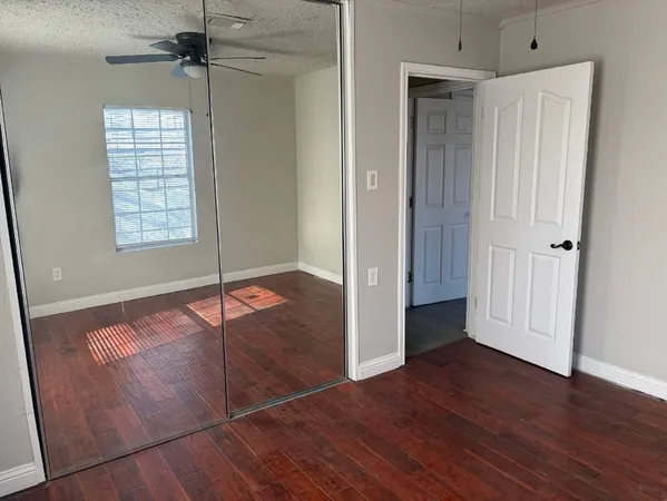 an empty room with wooden floor and a window