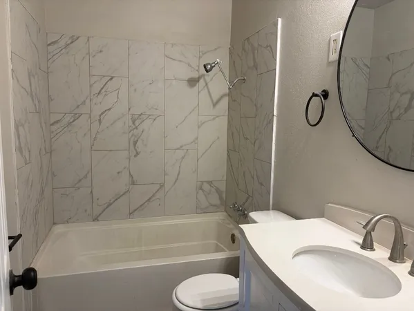a bathroom with a toilet sink and shower