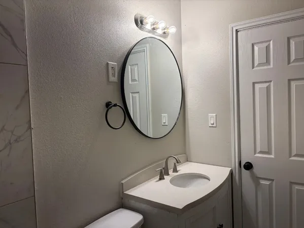 a bathroom with a sink and a mirror
