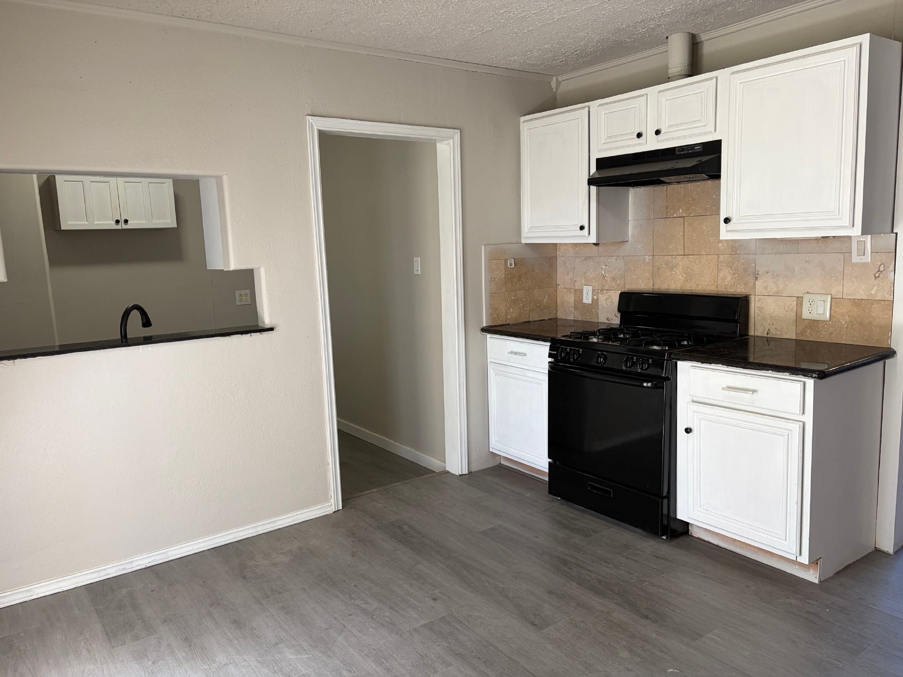 5406 Lyndhurst Drive Houston, TX 77033 - Photo 3 of 17 a kitchen with granite countertop a stove and a refrigerator