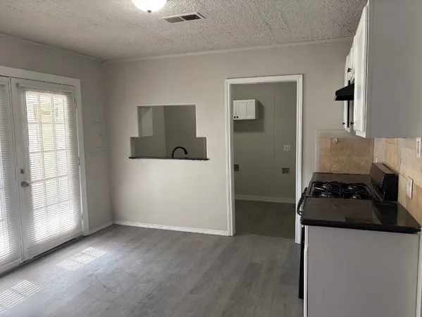 a kitchen with a stove and a refrigerator